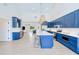Spacious kitchen with island, seamlessly connects to living area, complete with stainless steel appliances and ample storage at 18610 Fort Smith Cir, Port Charlotte, FL 33948