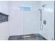 Elegant shower features marble tile, a pebble floor, a rain shower head and recessed shelving at 18610 Fort Smith Cir, Port Charlotte, FL 33948