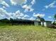 Spacious backyard featuring a well-maintained lawn and screened-in patio at 21287 Birwood Ave, Port Charlotte, FL 33954