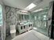 Modern bathroom with marble walls, double vanity, and a glass-enclosed shower at 21287 Birwood Ave, Port Charlotte, FL 33954