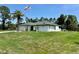 Charming home with a well-manicured lawn, garage and flagpole at 21287 Birwood Ave, Port Charlotte, FL 33954