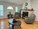 Cozy living room featuring a fireplace, hardwood floors, and comfortable seating at 21287 Birwood Ave, Port Charlotte, FL 33954