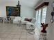 Bright living room featuring a modern white leather sectional sofa and stylish decor at 21287 Birwood Ave, Port Charlotte, FL 33954