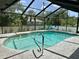 Relaxing screened-in pool area with clear blue water, chairs, and well-maintained deck at 21287 Birwood Ave, Port Charlotte, FL 33954