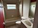 A well-lit bathroom offers a shower-tub combo, toilet, and vanity with sink, meeting essential needs at 2143 Santonian Ter, North Port, FL 34286