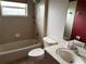 A well-lit bathroom offers a shower-tub combo, toilet, and vanity with sink, meeting essential needs at 2143 Santonian Ter, North Port, FL 34286