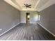 Spacious bedroom with dark wood-look laminate flooring and neutral walls at 2143 Santonian Ter, North Port, FL 34286