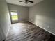 Bedroom with wood-look laminate flooring and natural light at 2143 Santonian Ter, North Port, FL 34286