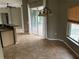 Tile dining area with chandelier and sliding doors at 2143 Santonian Ter, North Port, FL 34286
