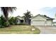 This single Gathering home showcases a two car garage, mature landscaping, and inviting curb appeal at 2143 Santonian Ter, North Port, FL 34286