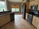Kitchen with wood cabinets and black appliances at 2143 Santonian Ter, North Port, FL 34286