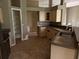 View of the kitchen featuring tile floors, beige cabinets, and open pantry at 2143 Santonian Ter, North Port, FL 34286