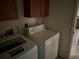 The laundry room features cabinets for storage and a washer and dryer for convenient laundry care at 2143 Santonian Ter, North Port, FL 34286
