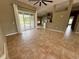 Open-concept living room with tile flooring and sliding glass doors at 2143 Santonian Ter, North Port, FL 34286