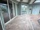 Covered patio with brick flooring and multiple sliding glass doors for indoor-outdoor living at 2143 Santonian Ter, North Port, FL 34286