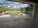 Screened-in pool and patio area overlooking the lawn at 2143 Santonian Ter, North Port, FL 34286