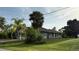 This single story home's backyard features lush grass and a view of the back of the home and part of the roof at 2143 Santonian Ter, North Port, FL 34286