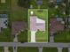 Aerial view of property showcasing the home's layout, sheds, and neighborhood surroundings at 21460 Sheldon Ave, Port Charlotte, FL 33952