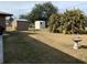 Large backyard featuring sheds for storage and a well-manicured lawn, offering endless possibilities for outdoor living at 21460 Sheldon Ave, Port Charlotte, FL 33952