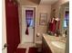 Well-maintained bathroom featuring granite countertop, dark wood cabinets, and a red accent color at 21460 Sheldon Ave, Port Charlotte, FL 33952