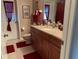 Well-maintained bathroom featuring granite countertop, dark wood cabinets, and a red accent color at 21460 Sheldon Ave, Port Charlotte, FL 33952