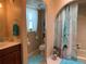 Well-lit bathroom with marble countertops, tile floor, and combined shower and tub at 21460 Sheldon Ave, Port Charlotte, FL 33952