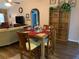 Open dining area adjacent to the living room, featuring a wooden table and tiled floors at 21460 Sheldon Ave, Port Charlotte, FL 33952