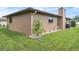 Exterior of home featuring well-maintained yard and a chimney at 21460 Sheldon Ave, Port Charlotte, FL 33952