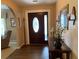 Elegant foyer with a stained-glass front door and decorative console table at 21460 Sheldon Ave, Port Charlotte, FL 33952