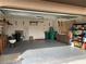 Spacious garage featuring concrete flooring, ample storage cabinets, and convenient access to the house interior at 21460 Sheldon Ave, Port Charlotte, FL 33952