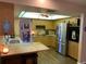 Modern kitchen with stainless steel appliances, wood cabinets, and an eat-in countertop at 21460 Sheldon Ave, Port Charlotte, FL 33952