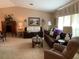 Spacious living room with plush carpeting, comfortable seating and plenty of natural light at 21460 Sheldon Ave, Port Charlotte, FL 33952
