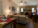 Open-concept living area featuring a stone fireplace, vaulted ceiling, and neutral tones at 21460 Sheldon Ave, Port Charlotte, FL 33952