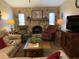 Comfortable living room with a unique stone fireplace and cozy furnishings at 21460 Sheldon Ave, Port Charlotte, FL 33952