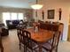 Open concept living and dining area with plush carpeting and dark wood furniture at 21460 Sheldon Ave, Port Charlotte, FL 33952