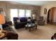 Comfortable living room with soft carpeting and lots of seating at 21460 Sheldon Ave, Port Charlotte, FL 33952