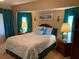 Comfortable carpeted main bedroom with ensuite bath access and bay windows at 21460 Sheldon Ave, Port Charlotte, FL 33952