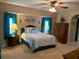 Comfortable carpeted main bedroom with ceiling fan, and ensuite bath access at 21460 Sheldon Ave, Port Charlotte, FL 33952