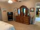 Carpeted main bedroom with wooden furniture and ensuite bath access at 21460 Sheldon Ave, Port Charlotte, FL 33952