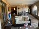 Inviting covered patio with a sofa, dining table and chairs, and decorative decor, creating a peaceful retreat at 21460 Sheldon Ave, Port Charlotte, FL 33952