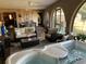 Relaxing covered patio with a spa, comfortable seating, and tropical decor, creating an inviting outdoor retreat at 21460 Sheldon Ave, Port Charlotte, FL 33952