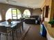 Relaxing covered patio with a spa, comfortable seating, and tropical decor with dining table and chairs at 21460 Sheldon Ave, Port Charlotte, FL 33952