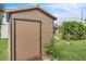 Durable backyard shed with wood siding, perfect for storing gardening tools and equipment, ensuring an organized yard at 21460 Sheldon Ave, Port Charlotte, FL 33952