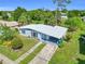 An aerial view of a single-story home with a covered carport and well-manicured lawn at 22219 Catherine Ave, Port Charlotte, FL 33952