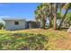 Backyard showcasing screened in porch and lovely greenery at 22219 Catherine Ave, Port Charlotte, FL 33952