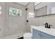 Updated bathroom with tile shower, new vanity and modern fixtures at 22219 Catherine Ave, Port Charlotte, FL 33952