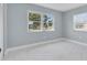 Bright bedroom with large windows and white marble-patterned tile flooring at 22219 Catherine Ave, Port Charlotte, FL 33952