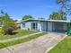 A single-story home featuring a covered carport and driveway leading to a well-maintained lawn at 22219 Catherine Ave, Port Charlotte, FL 33952