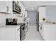 Modern kitchen with white cabinets, stainless steel appliances and quartz countertops at 22219 Catherine Ave, Port Charlotte, FL 33952