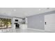 Bright kitchen and living area with white cabinets, stainless appliances, and white tile floors at 22219 Catherine Ave, Port Charlotte, FL 33952